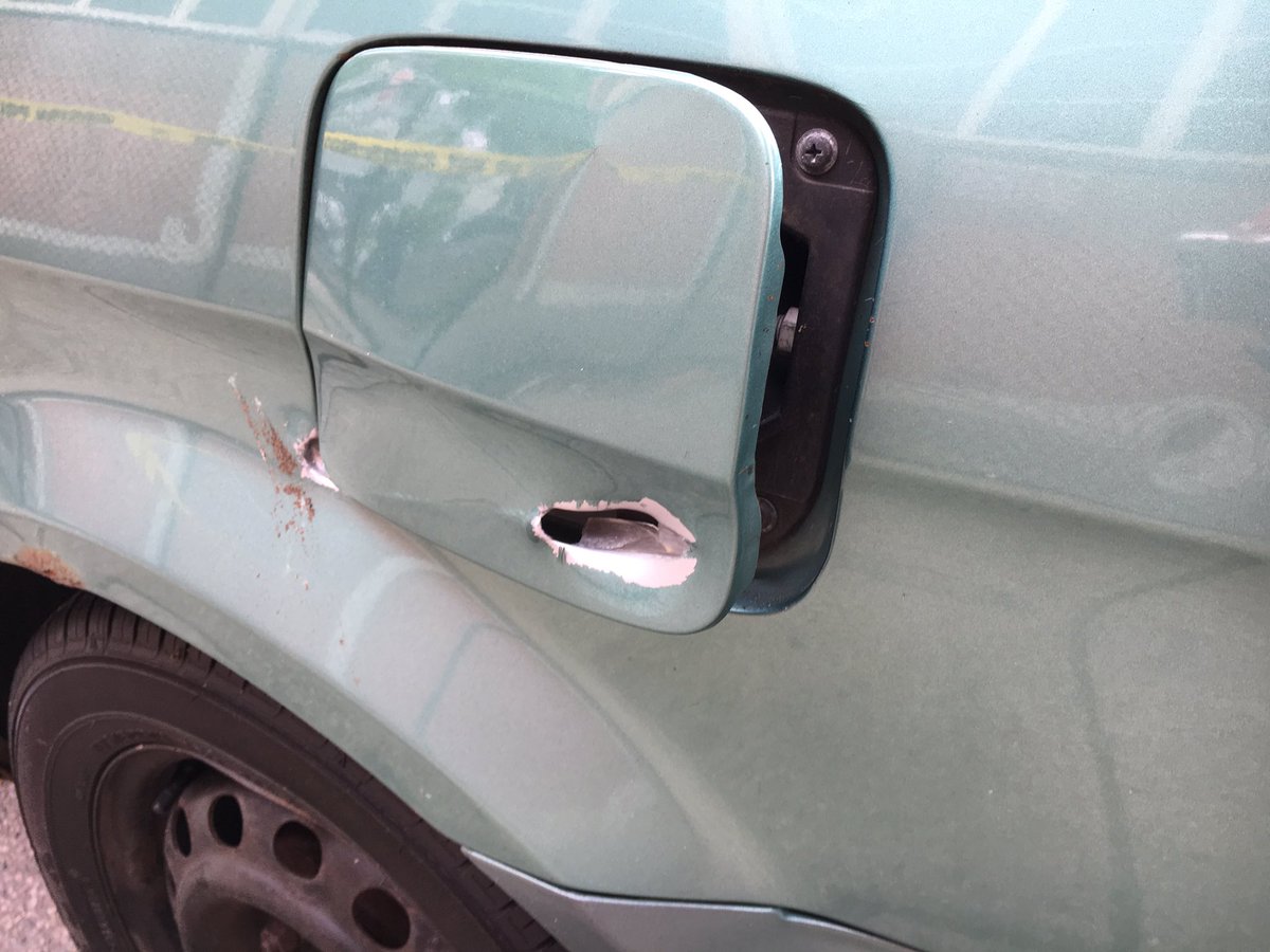 Police are back on the scene of last night's deadly double shooting. An officer is examining a bullet hole in a car and a shell casing found by the school. 