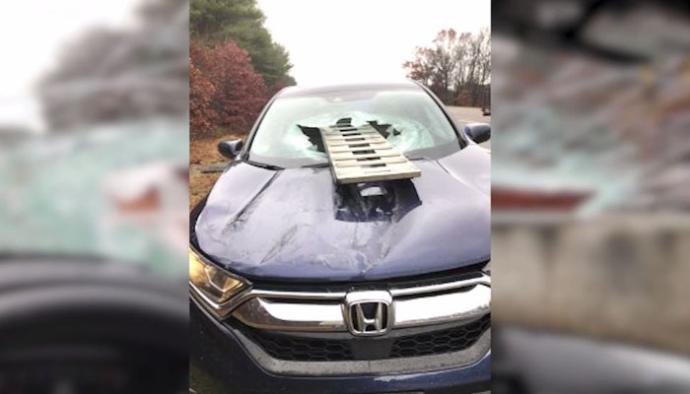 Woman ducks just in time to avoid truck ramp smashing through windshield