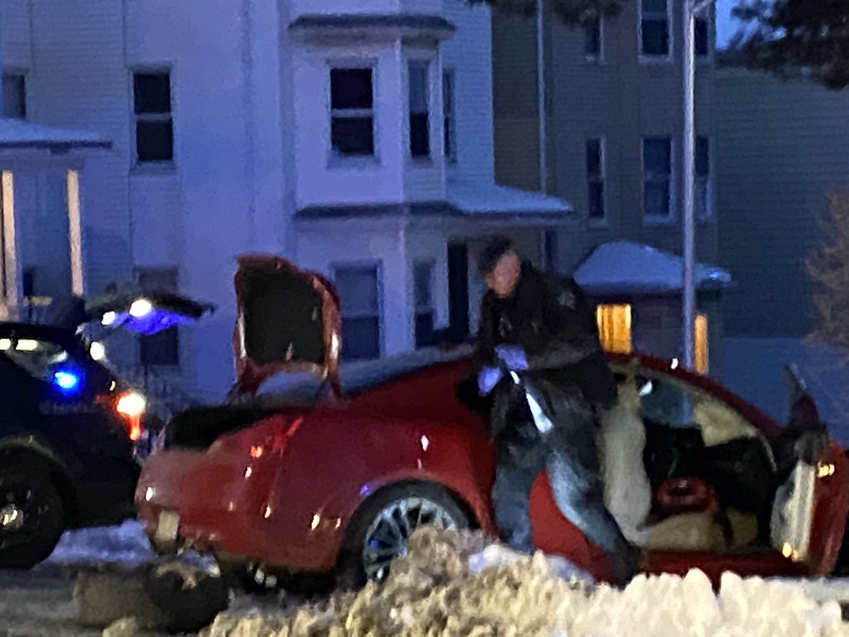 Officers searching the car pull out open bottle of liquor. WorcesterPD says two men in this car were taken to the hospital with minor injuries