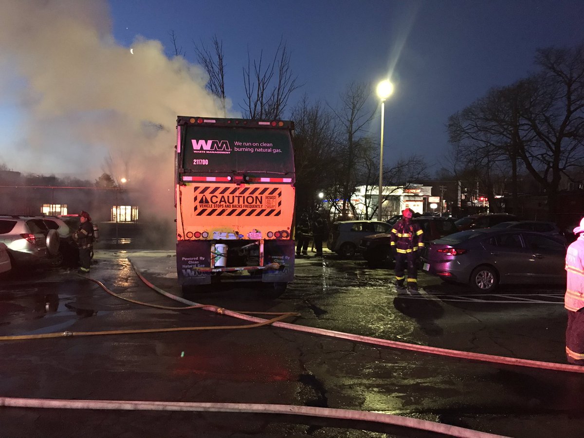 N. Pearl St. at the Stoughton line. Brockton firefighters fighting a trash truck fire extend to several cars.