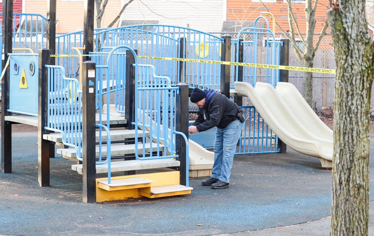 Somerville police officers are seen investigating a shooting this morning on Marshall St. The bullet missed the driver and landed in a nearby playground. 