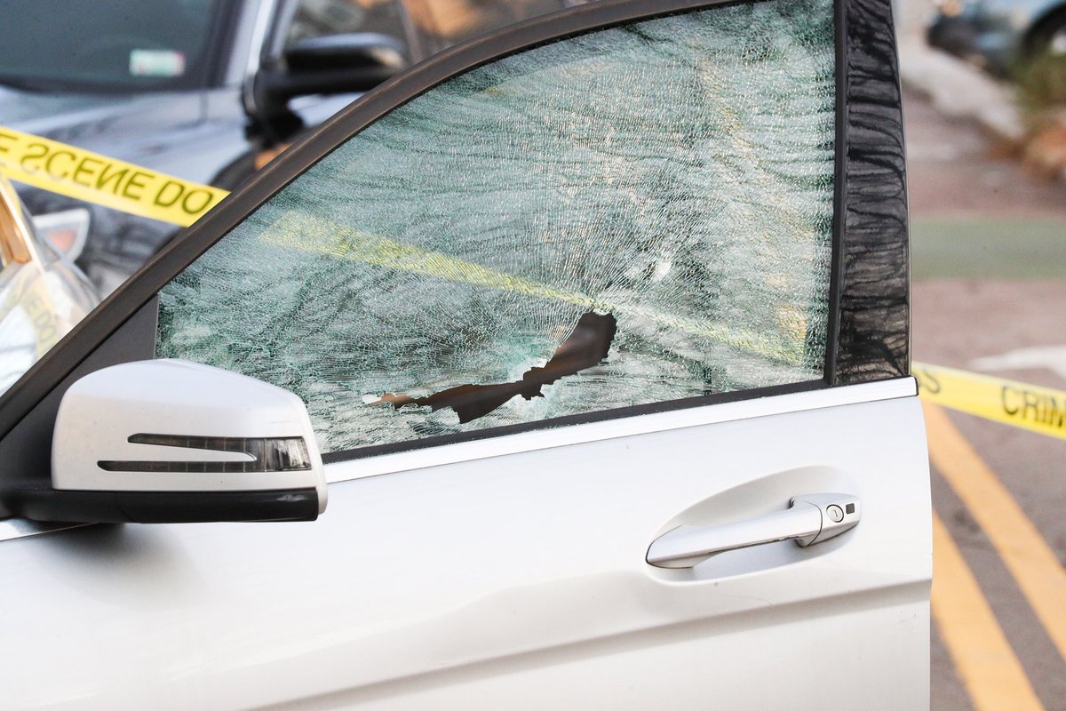 Somerville police officers are seen investigating a shooting this morning on Marshall St. The bullet missed the driver and landed in a nearby playground. 