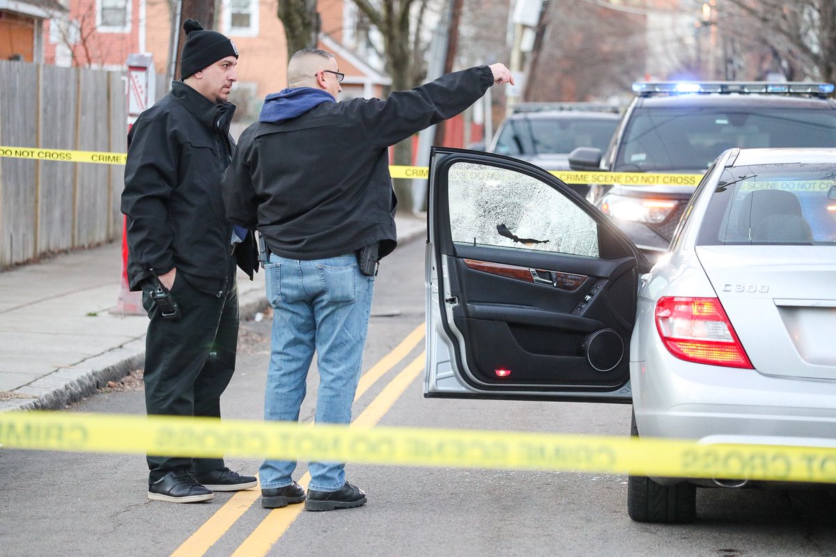 Somerville police officers are seen investigating a shooting this morning on Marshall St. The bullet missed the driver and landed in a nearby playground. 