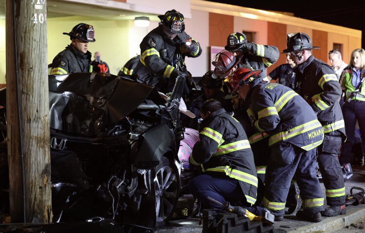 Brockton firefighters use the Jaws of Life hydraulic power tools to pry a woman from inside a car that crashed into a utility pole in front of the Rodeway Inn, 1005 Belmont st.