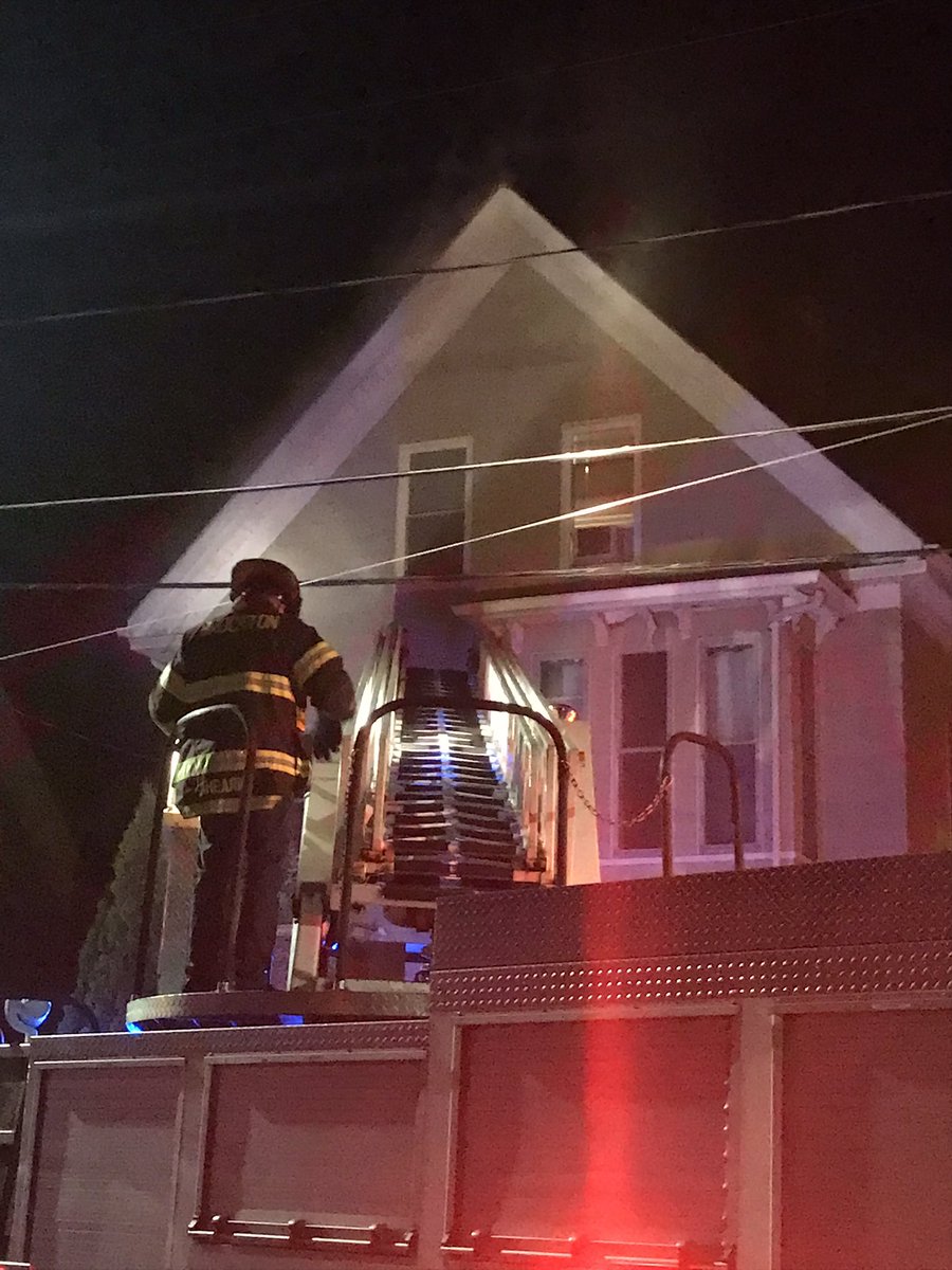 Smoke showing from a triple-decker home at 40 Calmar Street, Brockton