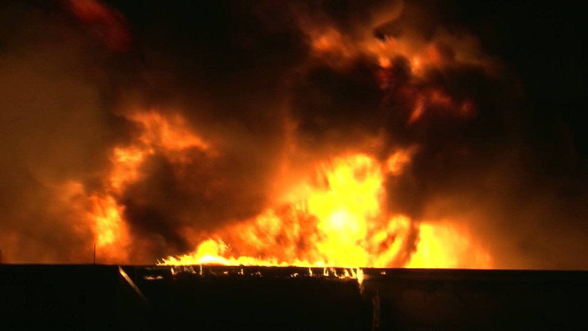 Fireballs erupt from the fire in Dudley this evening