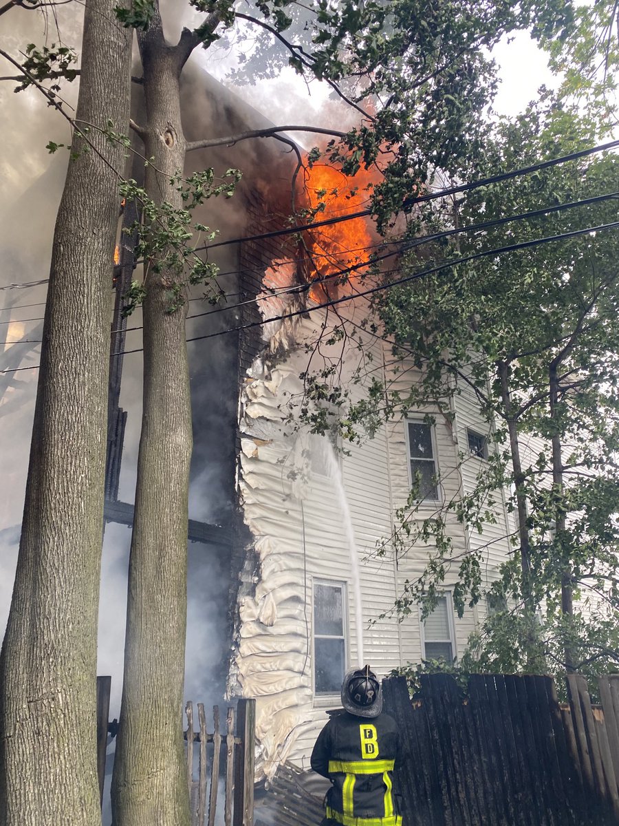 Heavy fire in the rear of a three family occupied building. The wind has pushed the fire to 3 surrounding buildings.This is now a 6th alarm