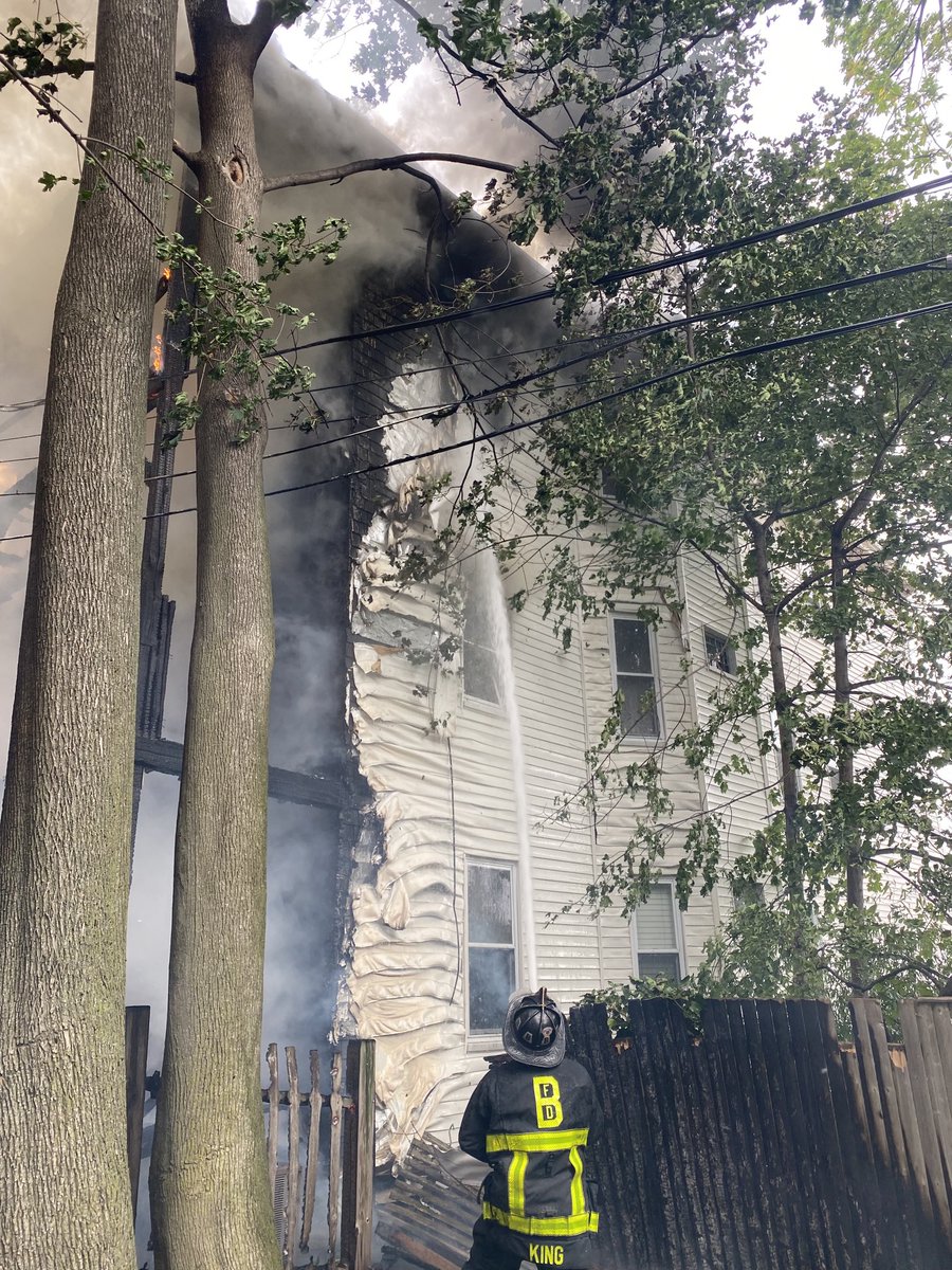 Heavy fire in the rear of a three family occupied building. The wind has pushed the fire to 3 surrounding buildings.This is now a 6th alarm