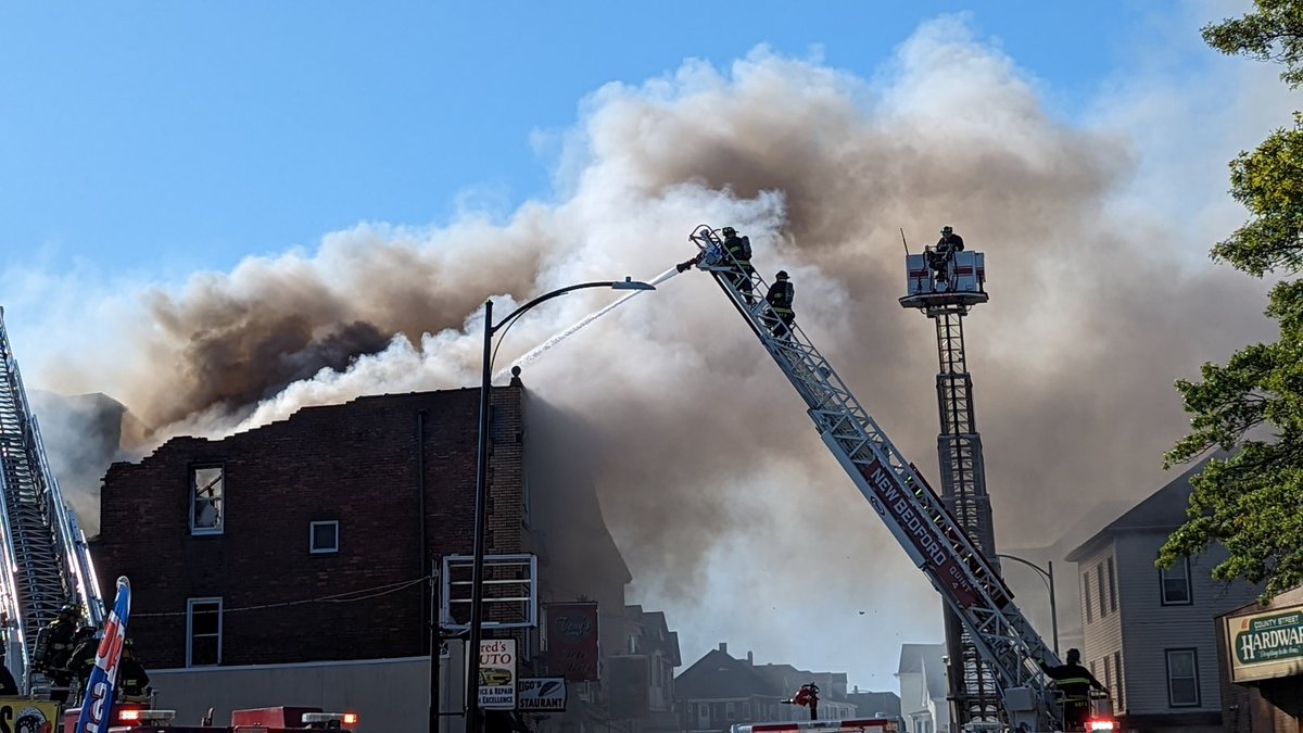 Large fire still being fought in New Bedford on county st