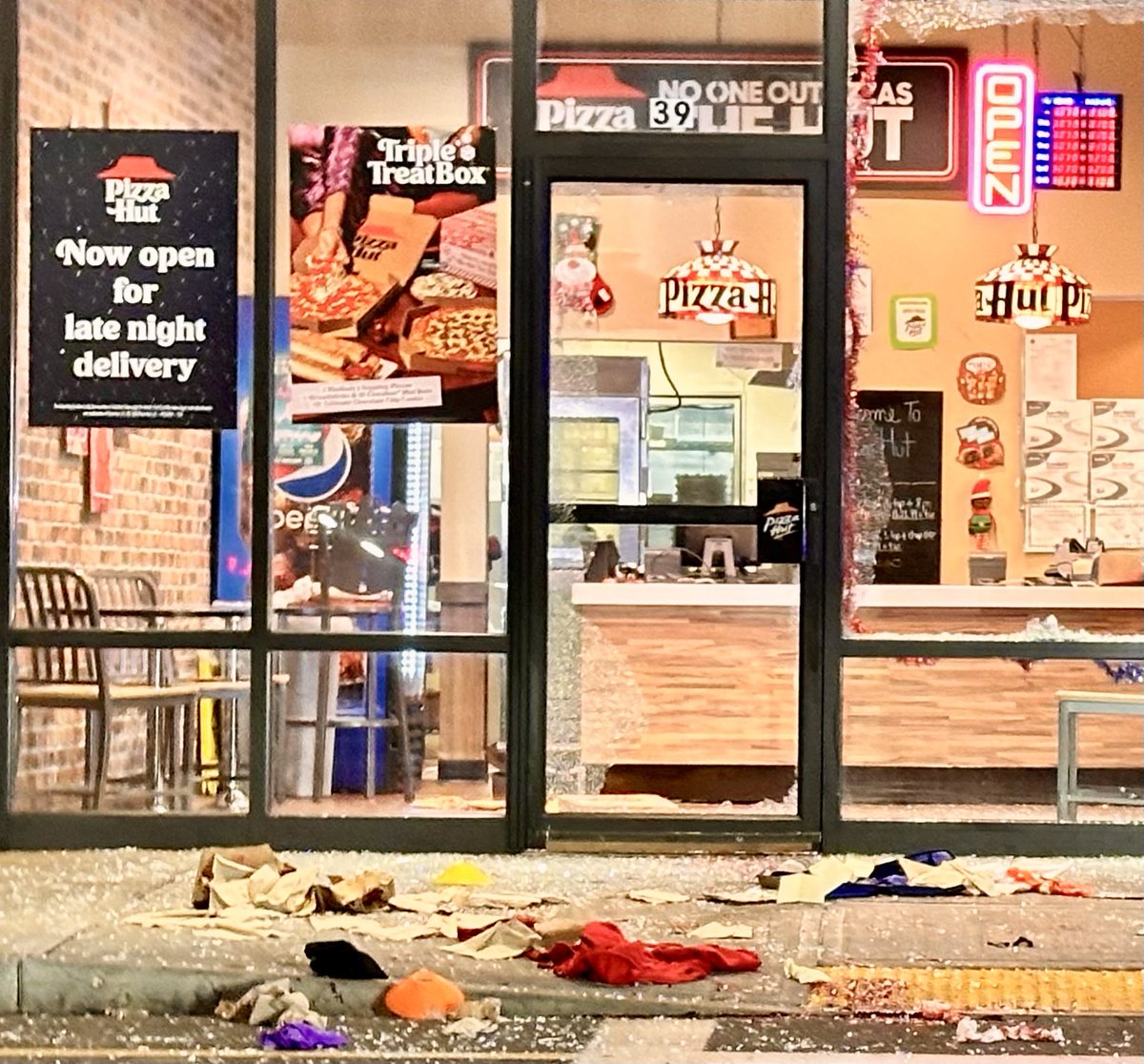 Window of Pizza Hut shot out during shooting on the Plaza they are in on State Street in Lynn, multiple people shot and taken to a Boston Hospital