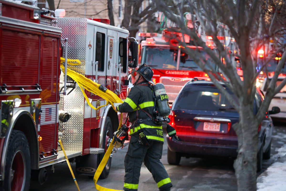 Cambridge Firefighters stretch a precautionary line at a reported structure fire on Saville St in West Cambridge. A small fire on the rear porch was quickly extinguished with a can and crews found no extension