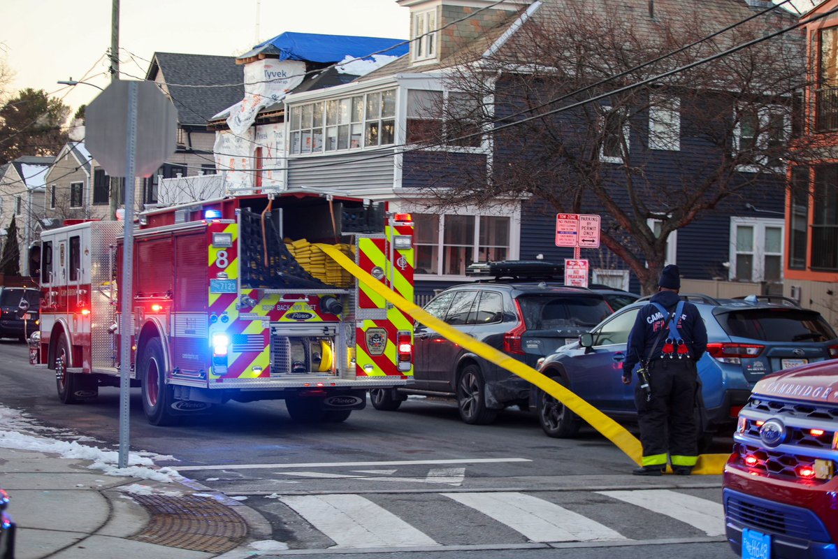 Cambridge Firefighters stretch a precautionary line at a reported structure fire on Saville St in West Cambridge. A small fire on the rear porch was quickly extinguished with a can and crews found no extension