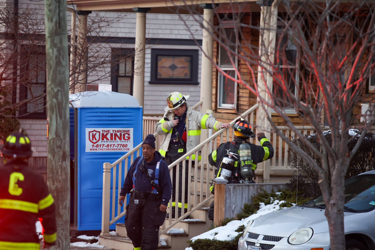 Cambridge Firefighters stretch a precautionary line at a reported structure fire on Saville St in West Cambridge. A small fire on the rear porch was quickly extinguished with a can and crews found no extension