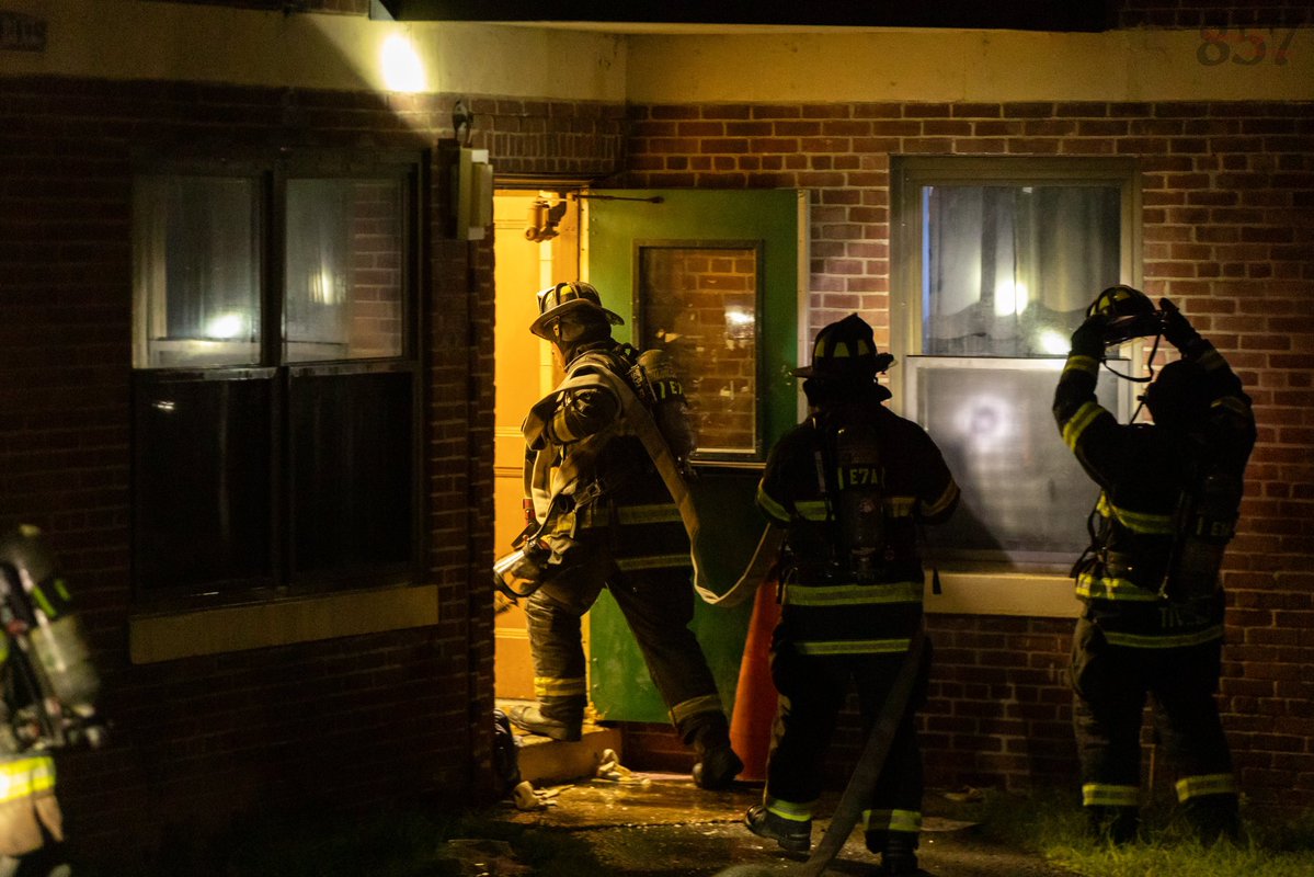 Somerville Firefighters work to battle a 2 alarm fire that consumed a second floor apartment in a 3 story public housing building on Powder House Blvd, late Sunday night