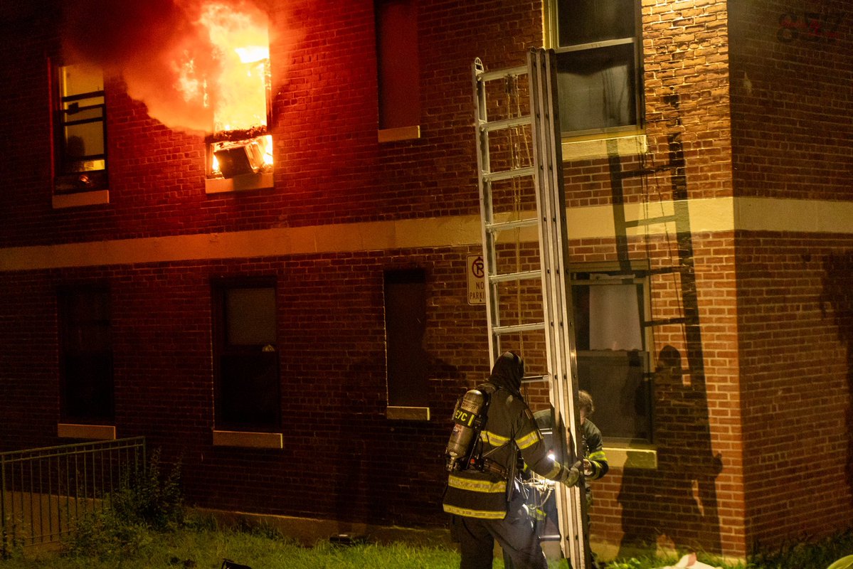 Somerville Firefighters work to battle a 2 alarm fire that consumed a second floor apartment in a 3 story public housing building on Powder House Blvd, late Sunday night