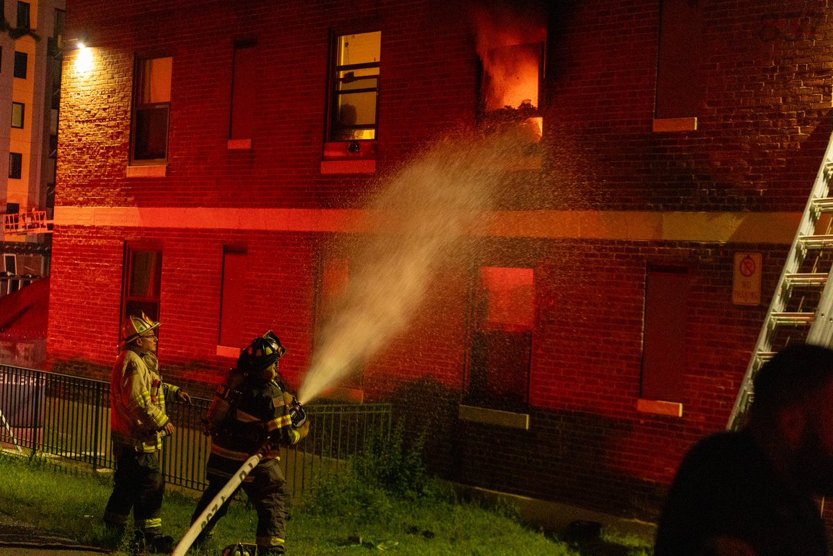 Somerville Firefighters work to battle a 2 alarm fire that consumed a second floor apartment in a 3 story public housing building on Powder House Blvd, late Sunday night