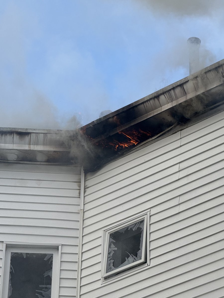 Firefighters continue to chase the fire in the eaves and roof at the 2 alarm fire on Washington st Roslindale.This is a 3 family home