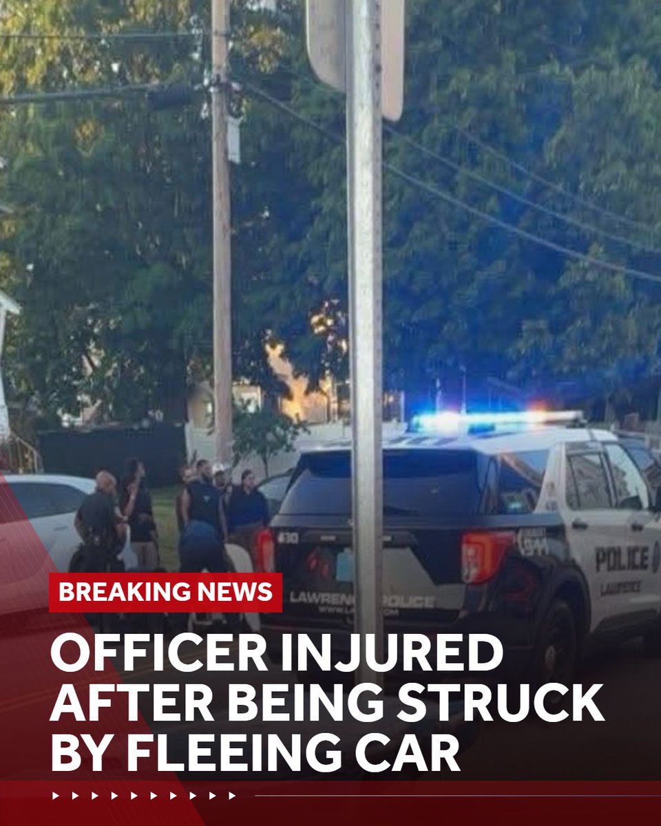 A Lawrence police officer was seriously injured after being struck and dragged by a car during a traffic stop, officials said